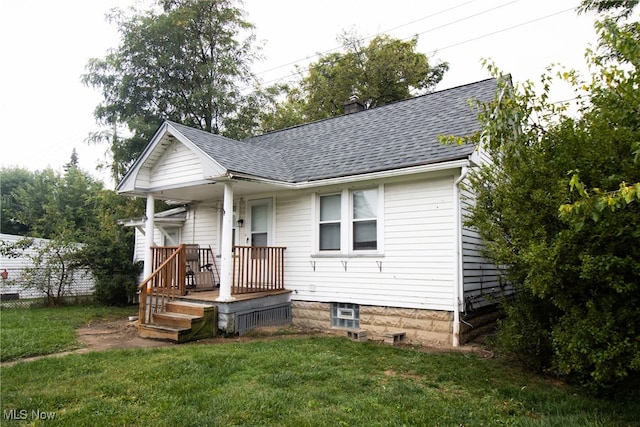 bungalow-style home with a porch and a front lawn