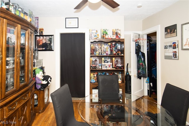 dining space with ceiling fan, hardwood / wood-style flooring, and a textured ceiling