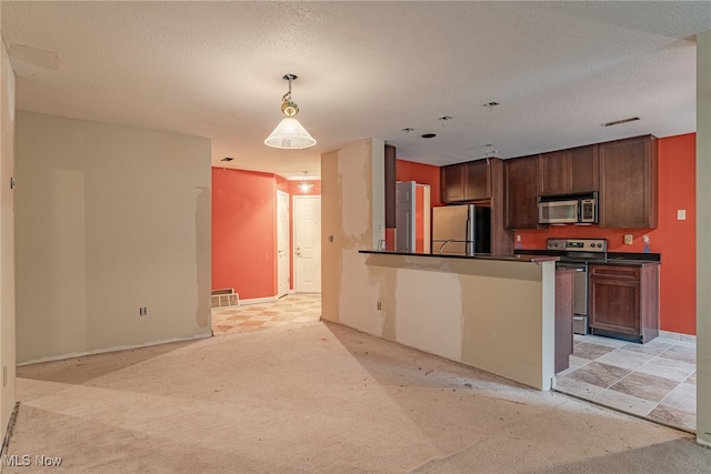 kitchen with light colored carpet, a textured ceiling, appliances with stainless steel finishes, and hanging light fixtures