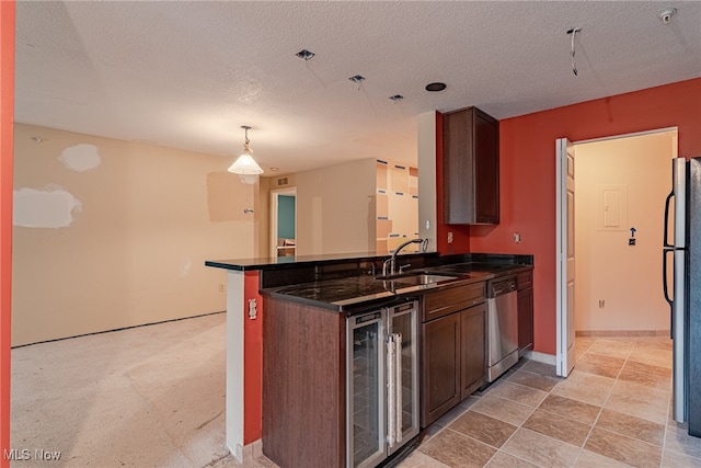 kitchen featuring sink, kitchen peninsula, beverage cooler, a textured ceiling, and appliances with stainless steel finishes