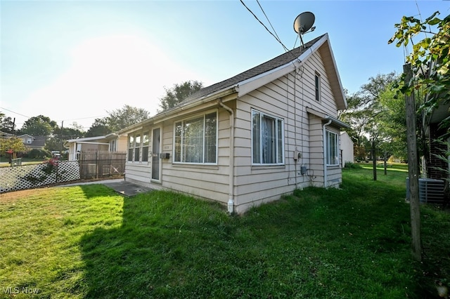 view of side of property featuring a yard