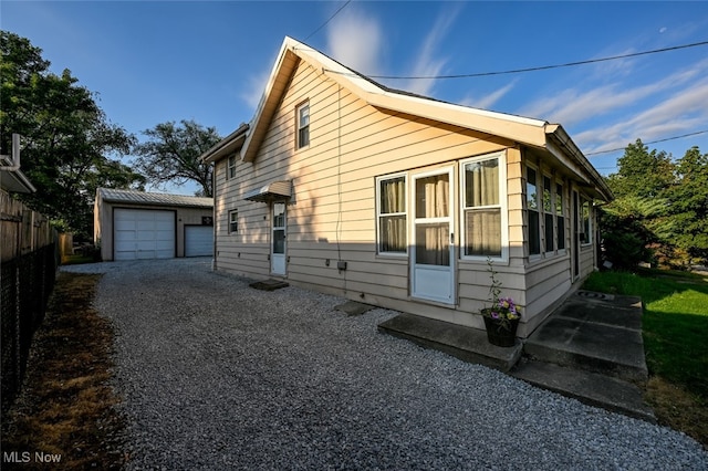 view of side of home featuring an outdoor structure and a garage