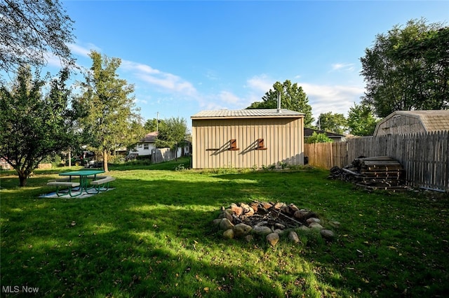 view of yard with a storage unit and a fire pit