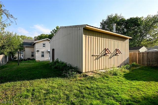 view of outbuilding featuring a lawn