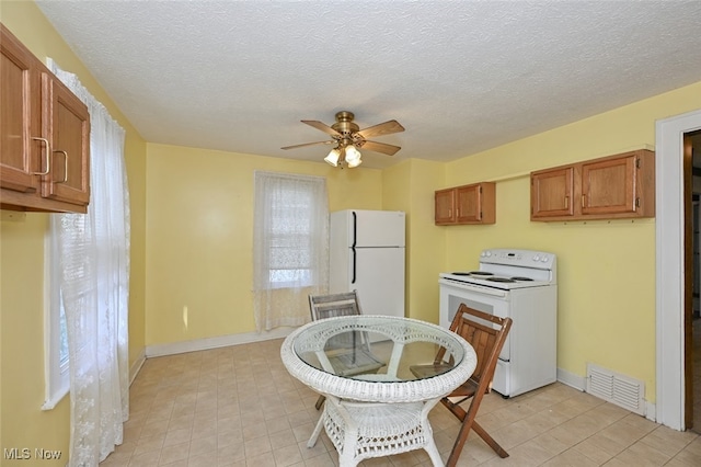 dining room featuring a textured ceiling and ceiling fan