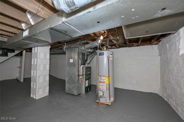 basement featuring water heater and heating unit