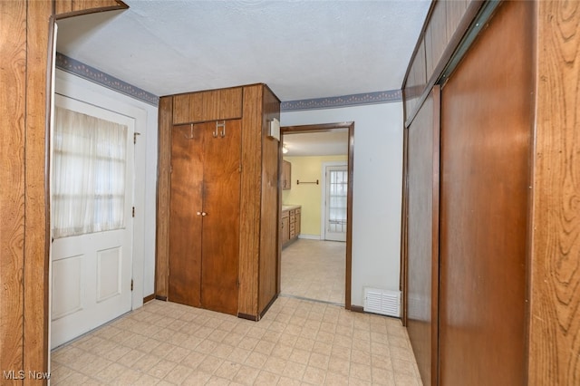 hallway with a textured ceiling and a wealth of natural light