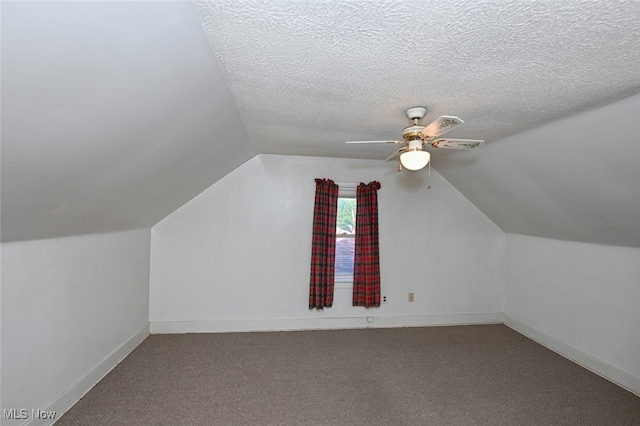 additional living space featuring carpet floors, a textured ceiling, lofted ceiling, and ceiling fan