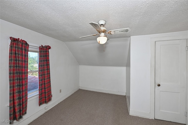 additional living space with lofted ceiling, ceiling fan, carpet floors, and a textured ceiling