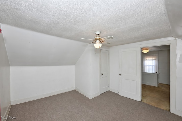 bonus room with ceiling fan, vaulted ceiling, a textured ceiling, and carpet flooring