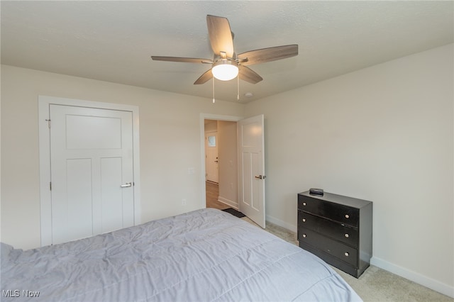 bedroom with ceiling fan and light carpet