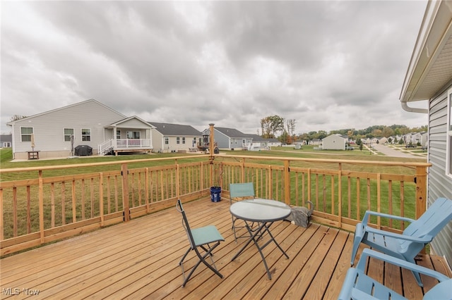 wooden deck with a lawn