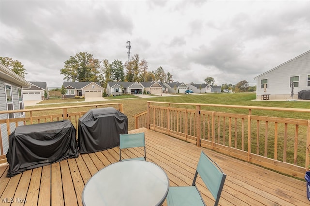 wooden deck with a grill and a garage