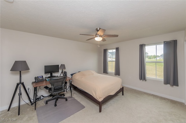 bedroom featuring multiple windows, carpet floors, and ceiling fan