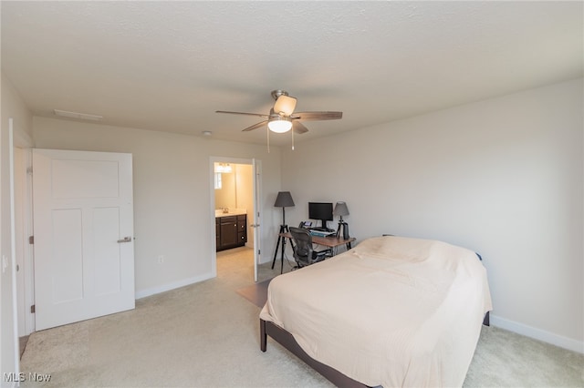 carpeted bedroom with ceiling fan, a textured ceiling, and connected bathroom