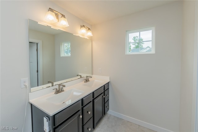 bathroom with vanity, tile patterned flooring, and a healthy amount of sunlight