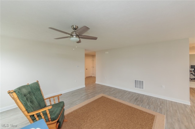 sitting room featuring light hardwood / wood-style flooring and ceiling fan