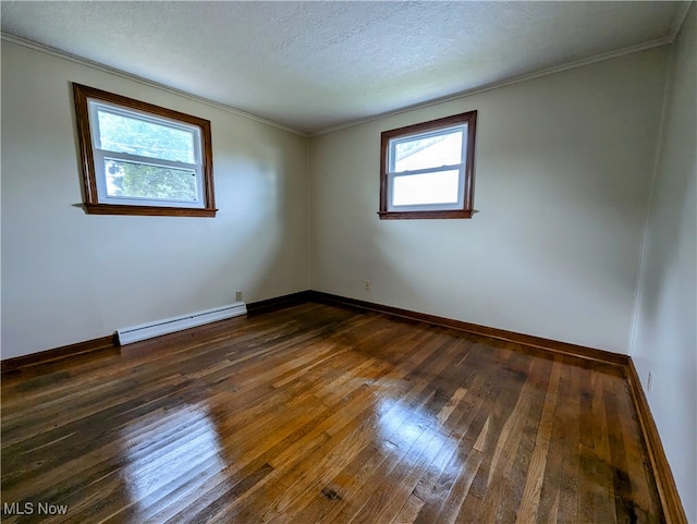 spare room with ornamental molding, a baseboard heating unit, a textured ceiling, and dark hardwood / wood-style floors