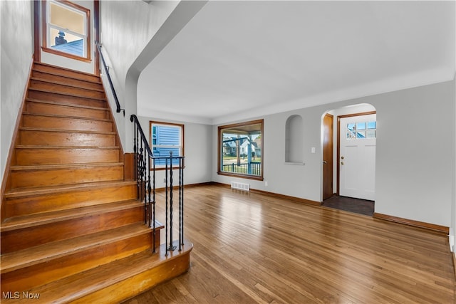 staircase with hardwood / wood-style flooring