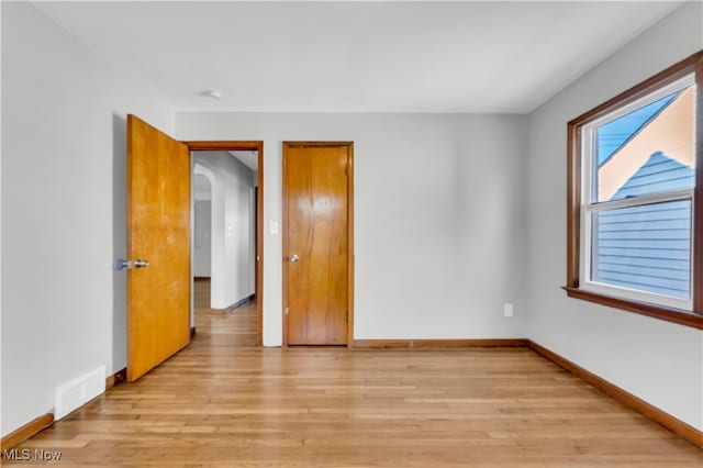 unfurnished room with light hardwood / wood-style floors