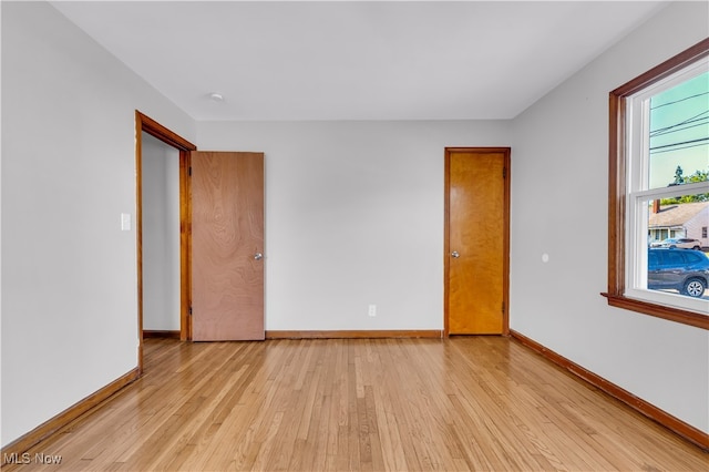 spare room with light hardwood / wood-style flooring