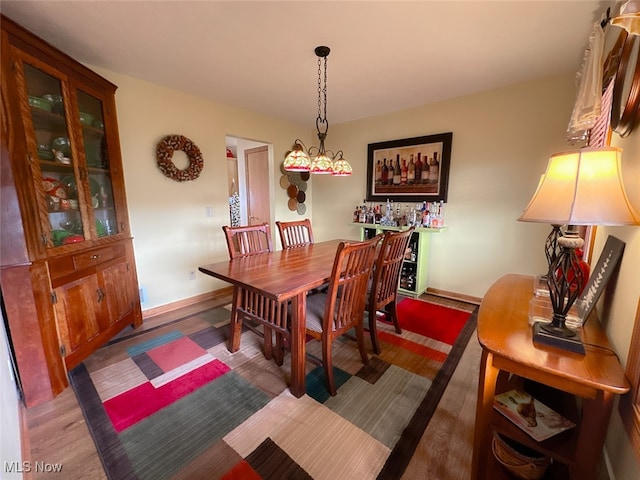 dining space with dark wood-type flooring