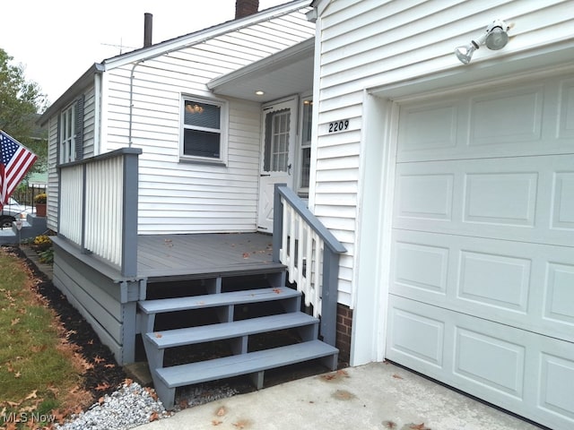 doorway to property featuring a wooden deck and a garage