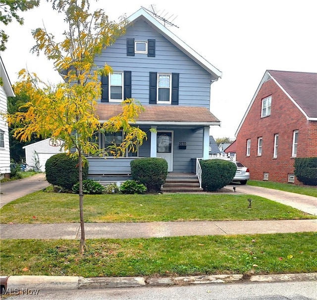 view of front of home with a front yard and a porch