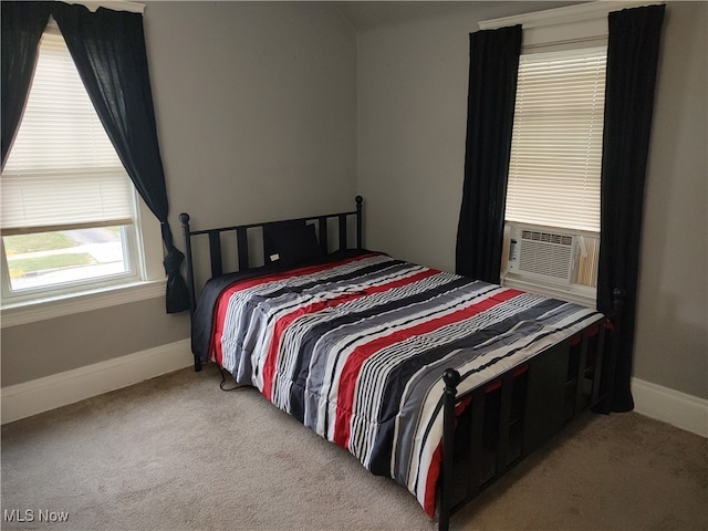 bedroom featuring light carpet and cooling unit