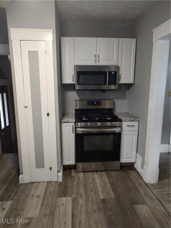 kitchen with stainless steel appliances and white cabinets