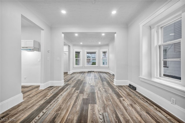 unfurnished living room with dark wood-type flooring