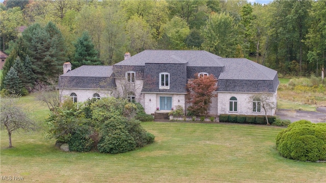 french country style house with a front lawn