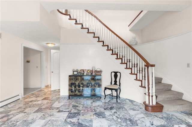 staircase with a baseboard radiator and a high ceiling