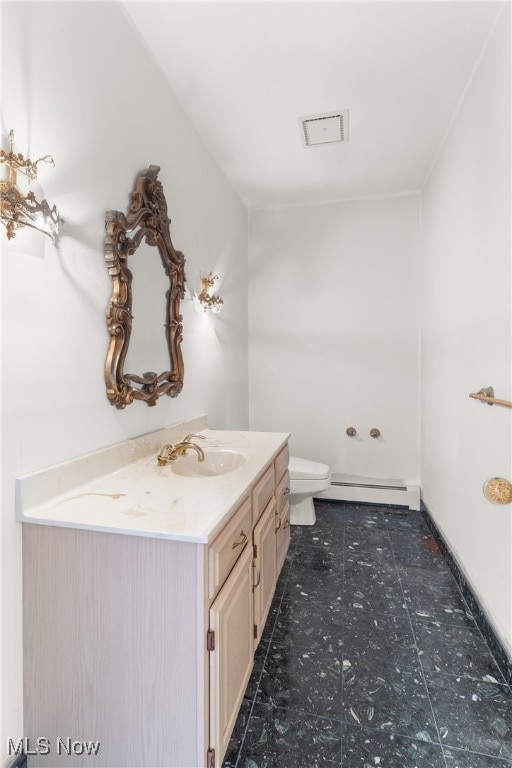 bathroom featuring vanity, toilet, and a baseboard heating unit