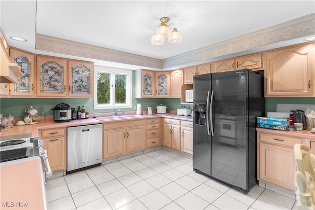 kitchen with light tile patterned flooring, light brown cabinets, dishwasher, sink, and black fridge