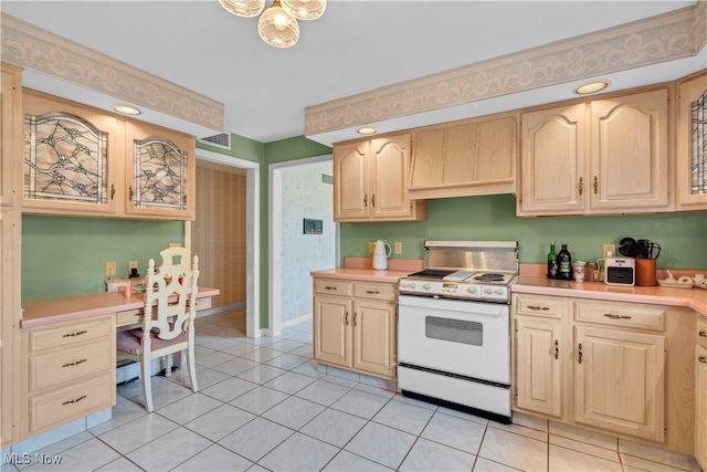 kitchen with white stove, light tile patterned flooring, and light brown cabinetry