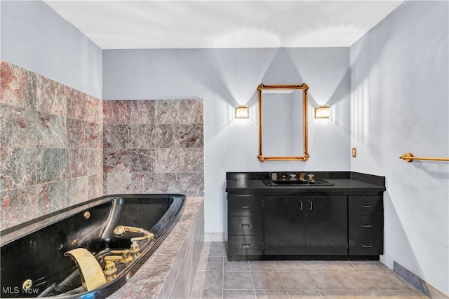 bathroom featuring tiled bath, vanity, and tile patterned floors