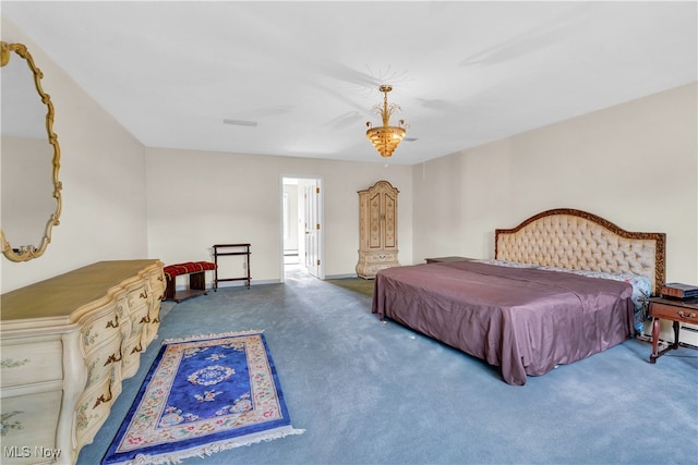 bedroom with carpet floors and a chandelier