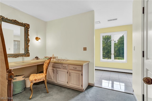 carpeted home office with a baseboard heating unit and built in desk