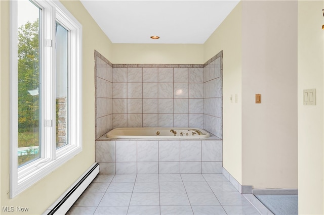 bathroom with a baseboard heating unit, tiled tub, and tile patterned floors