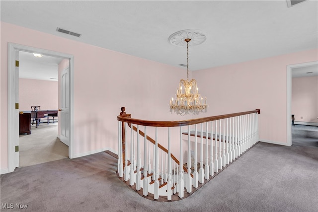 hall with carpet floors, a notable chandelier, and a baseboard radiator