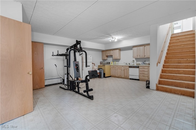 workout area featuring a textured ceiling and sink