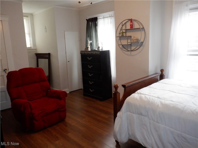 bedroom with multiple windows, crown molding, and dark hardwood / wood-style floors