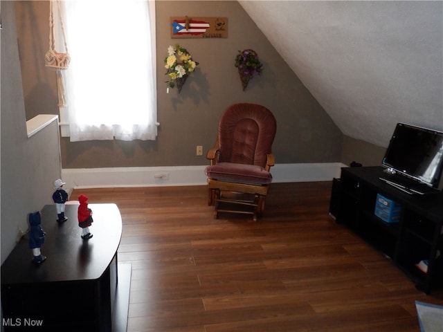 sitting room with vaulted ceiling and dark hardwood / wood-style floors