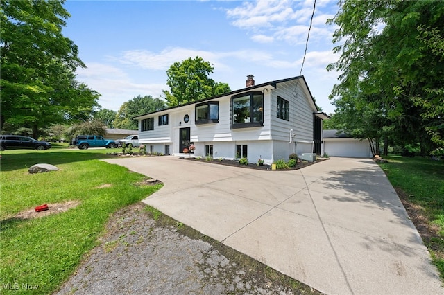 raised ranch with a front yard and a garage