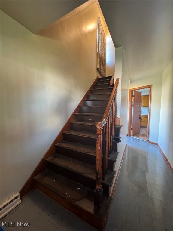 stairway with a baseboard radiator