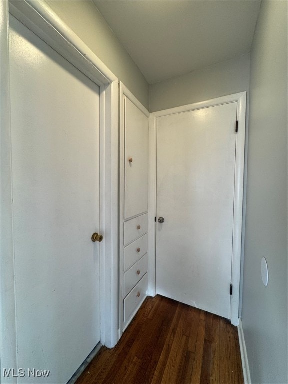 corridor featuring dark wood-type flooring