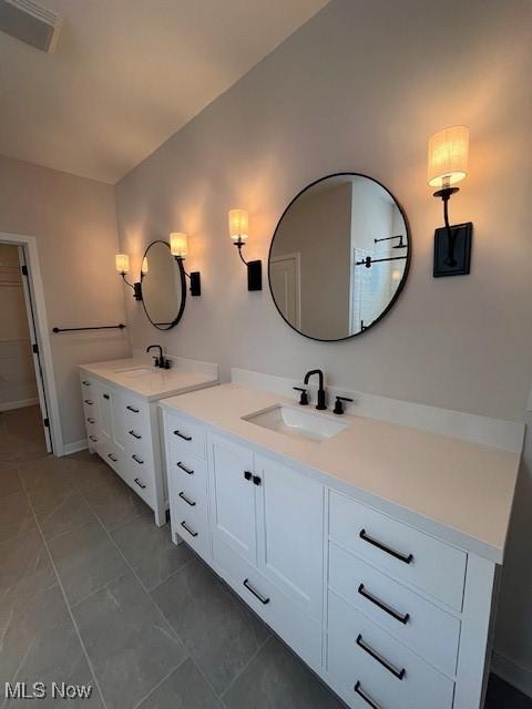 bathroom featuring tile patterned flooring and vanity