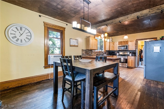 dining room with an inviting chandelier, dark hardwood / wood-style floors, and sink