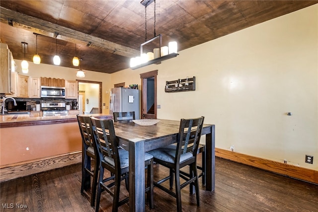 dining room with dark hardwood / wood-style floors and sink